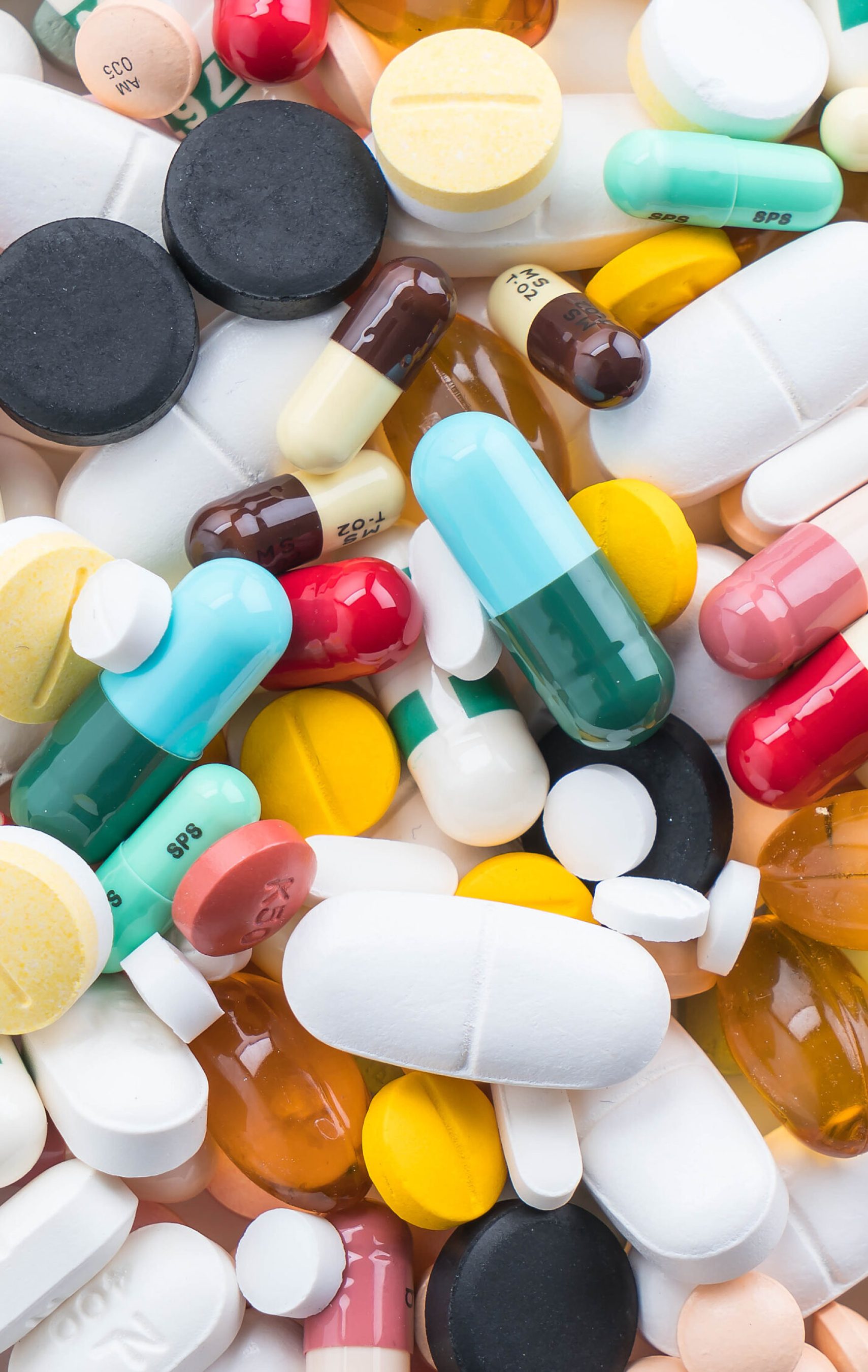 packings of pills and capsules of medicines on white background